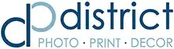 zensmart is showing Logo for "district," featuring the initials "dp" in a stylized design. "district" is written in lowercase letters in a modern font. Below, there are the words "PHOTO - PRINT - DECOR" in a smaller font, indicating the services provided. The color scheme is blue. with print workflow automation