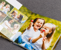 zensmart is showing An open photo album displays pictures of two young girls laughing and holding red lollipops outdoors, with additional small photos of them playing together on a grassy background. with print workflow automation